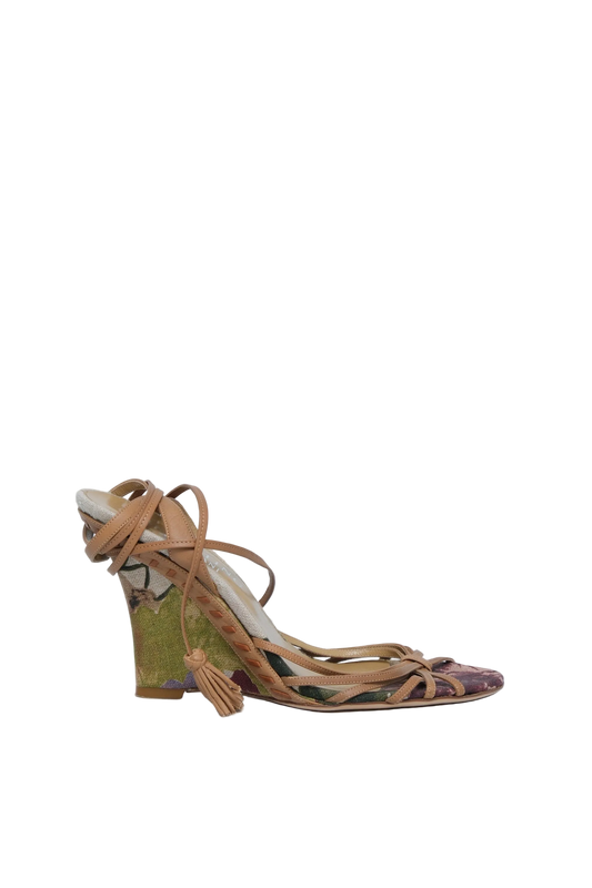 A single women's strappy sandal with a chunky block heel, featuring tan leather straps and a patterned heel counter in olive green, black, and purple, set against a plain light gray background.