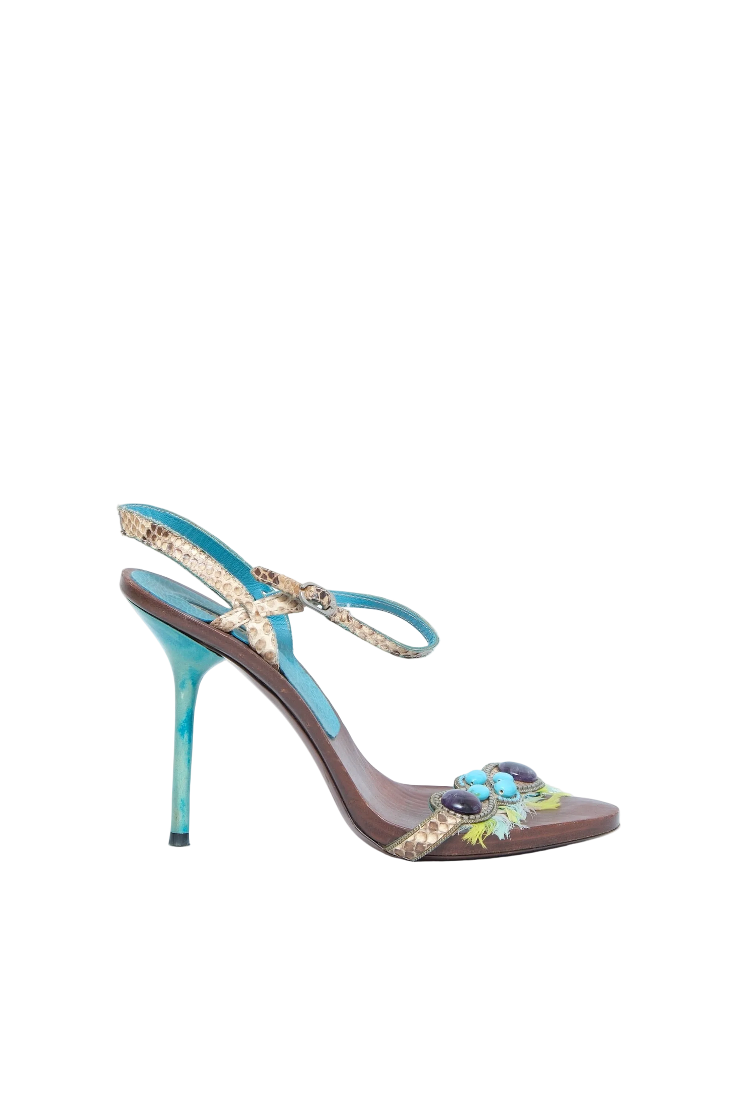 A single women's high-heeled sandal with a brown leather base, turquoise blue straps, and a decorative floral embellishment on the toe strap, shown against a light blue background.