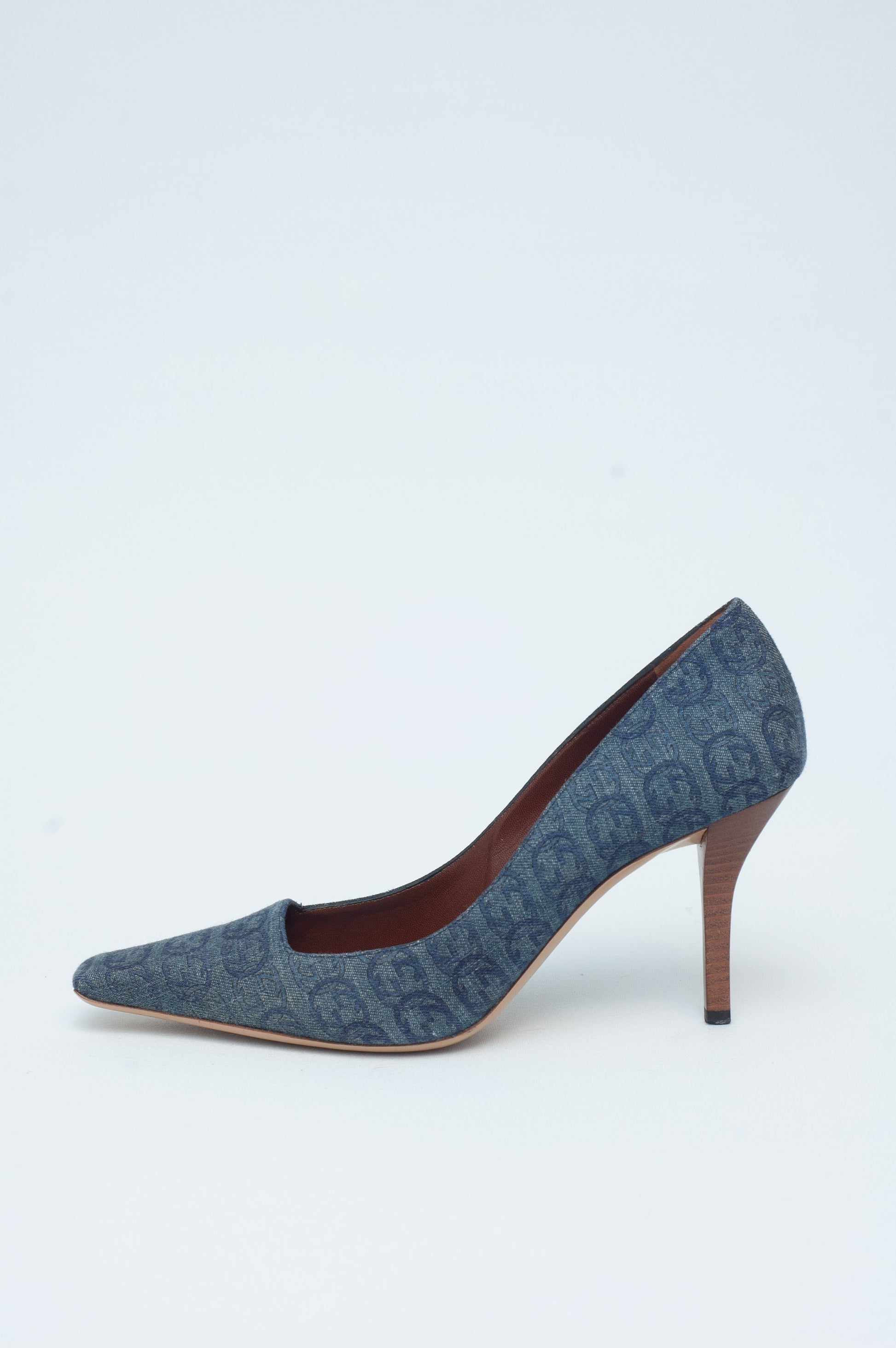 Blue denim high-heeled shoe on a light gray background