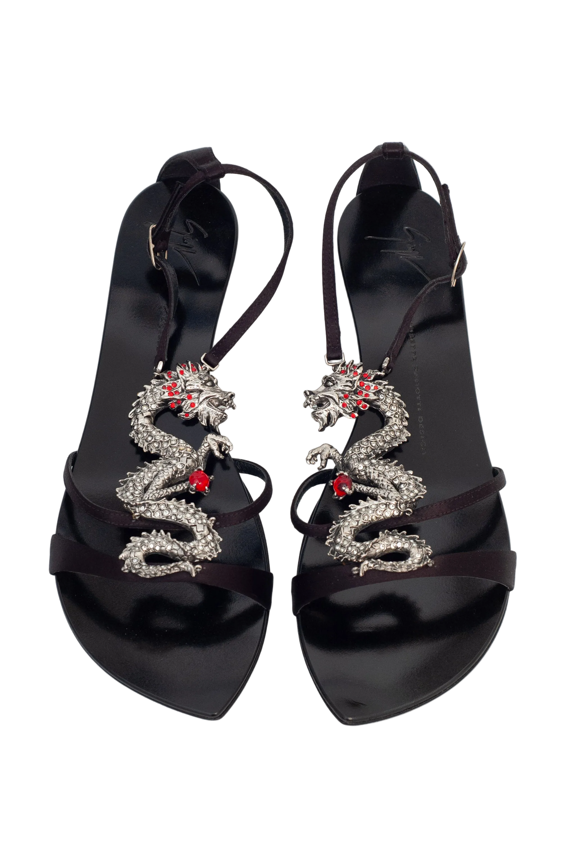 Black high-heeled sandals with snake designs on a white background