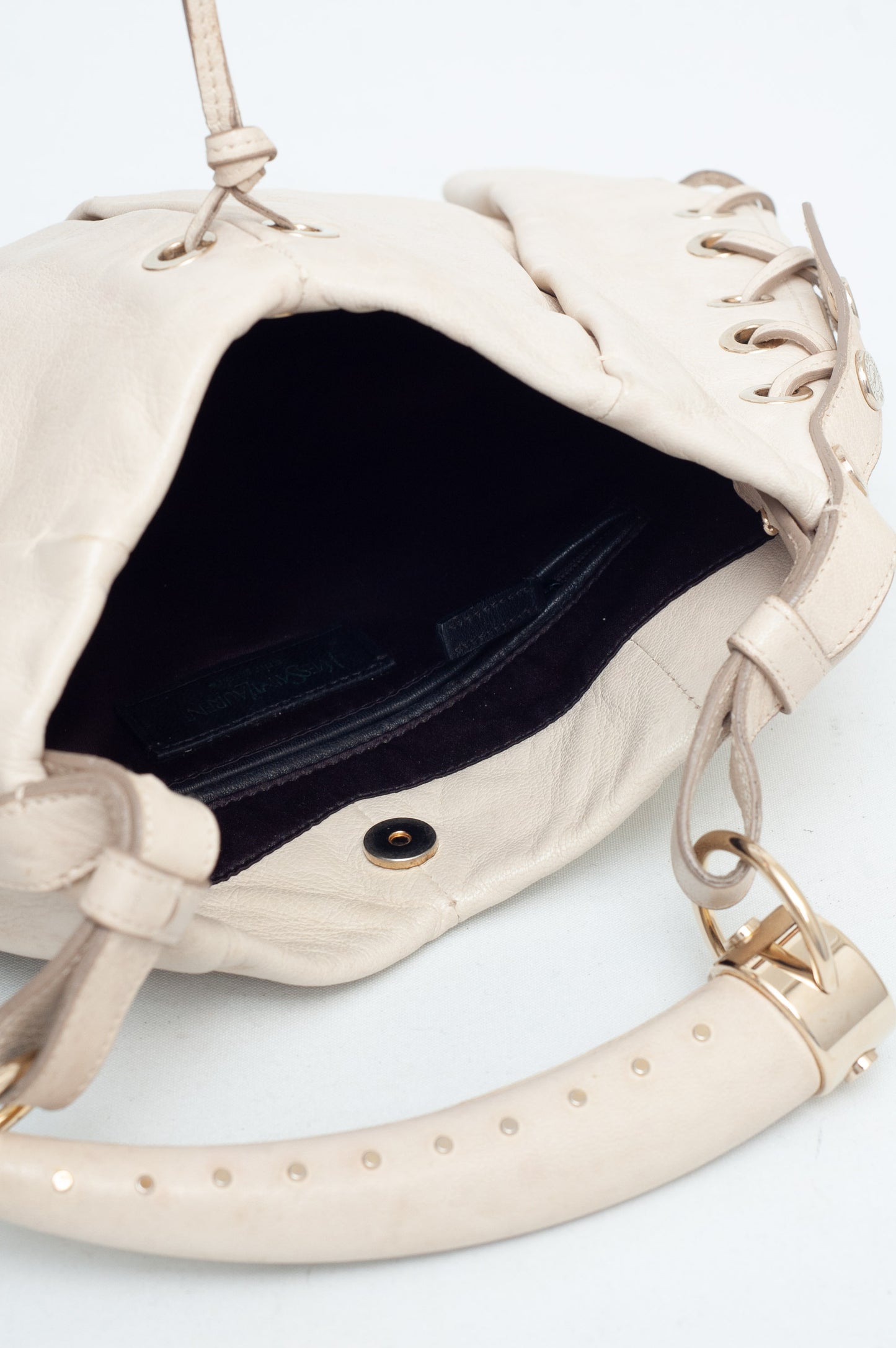 Beige handbag with a black interior on a white background