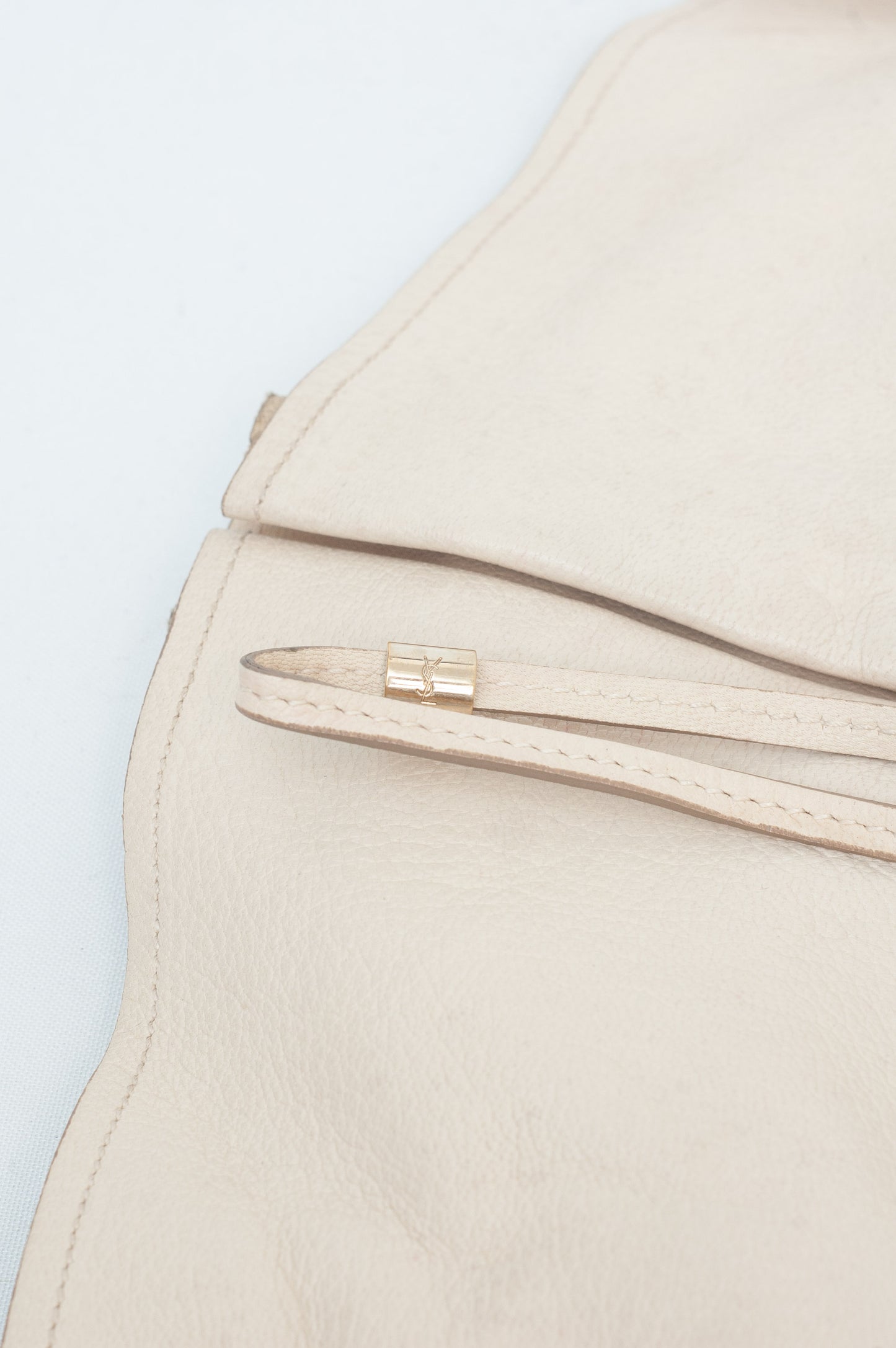 Close-up of a beige jacket with a zipper on a light blue background