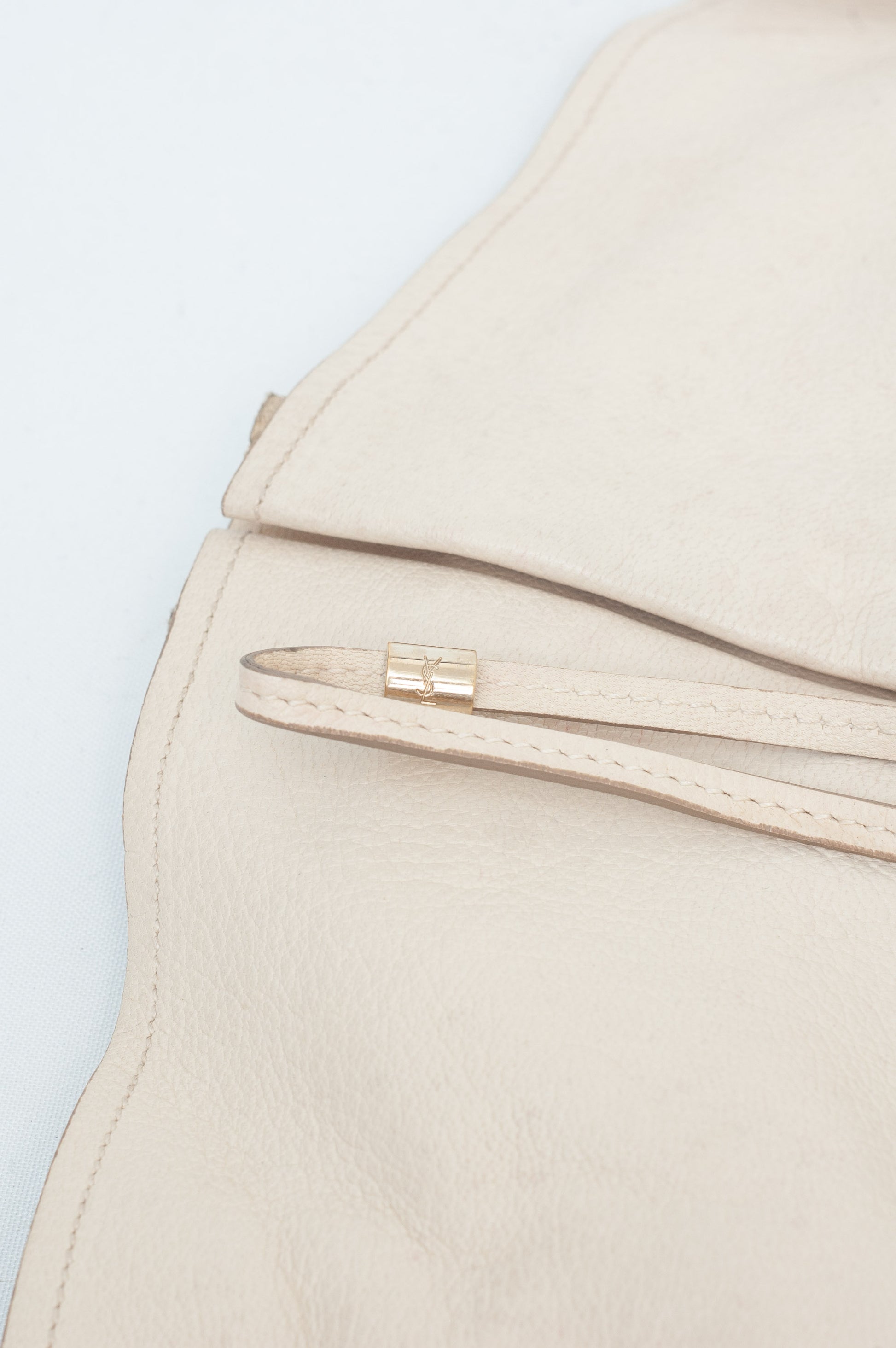 Close-up of a beige jacket with a zipper on a light blue background