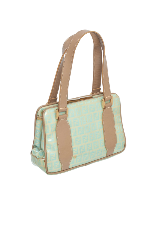Handbag with light blue pattern and brown straps on a white background