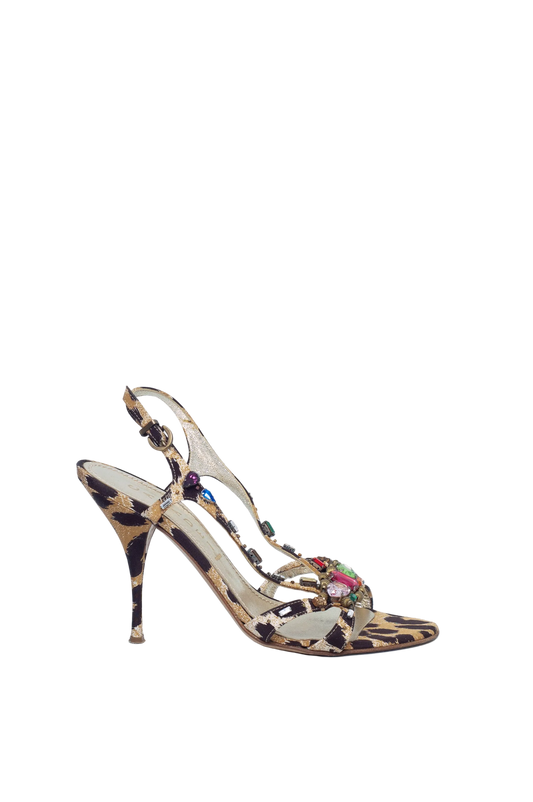 High-heeled sandal with leopard print and floral details on a light blue background