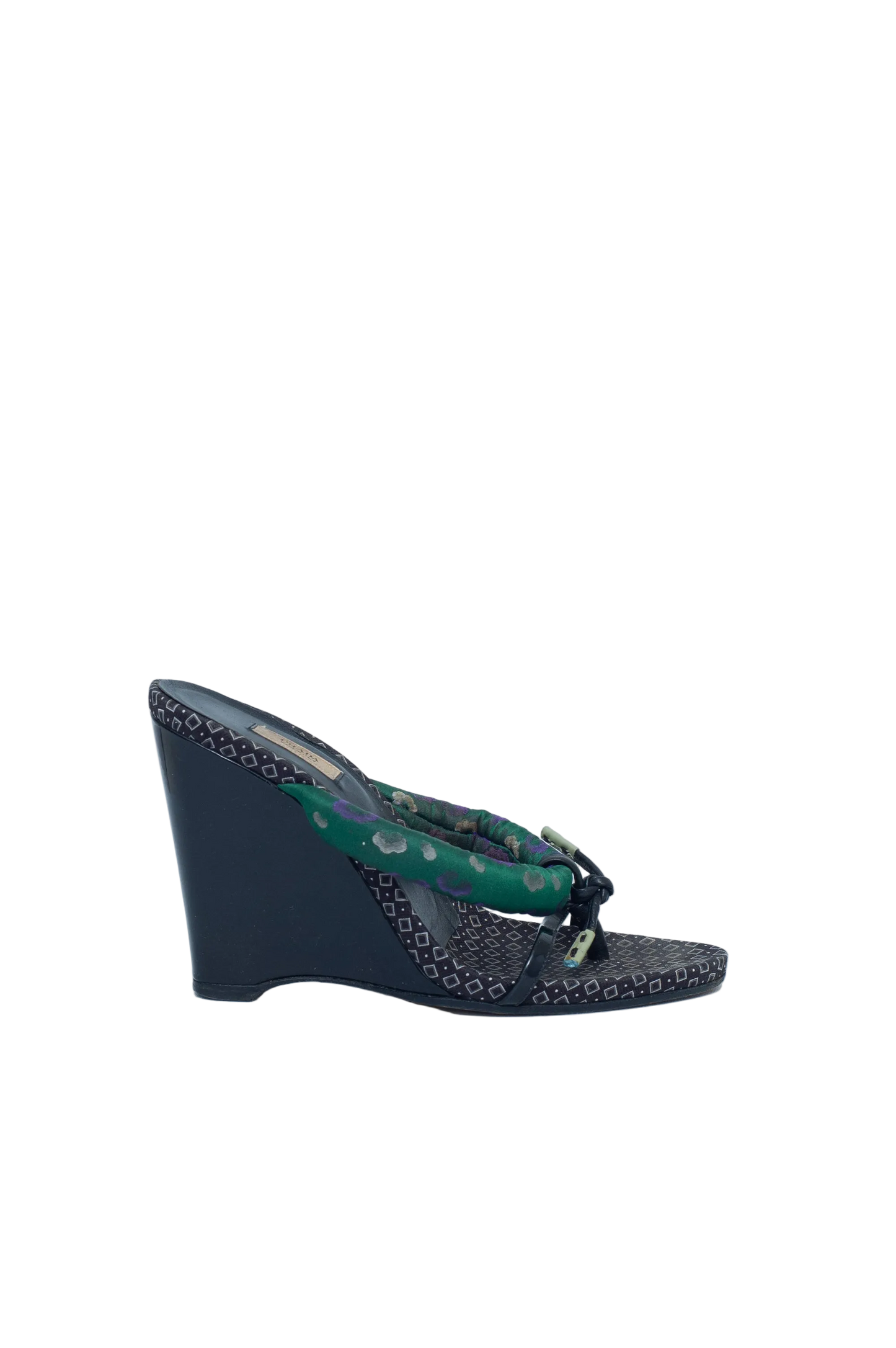 Black wedge sandal with green pattern on a white background