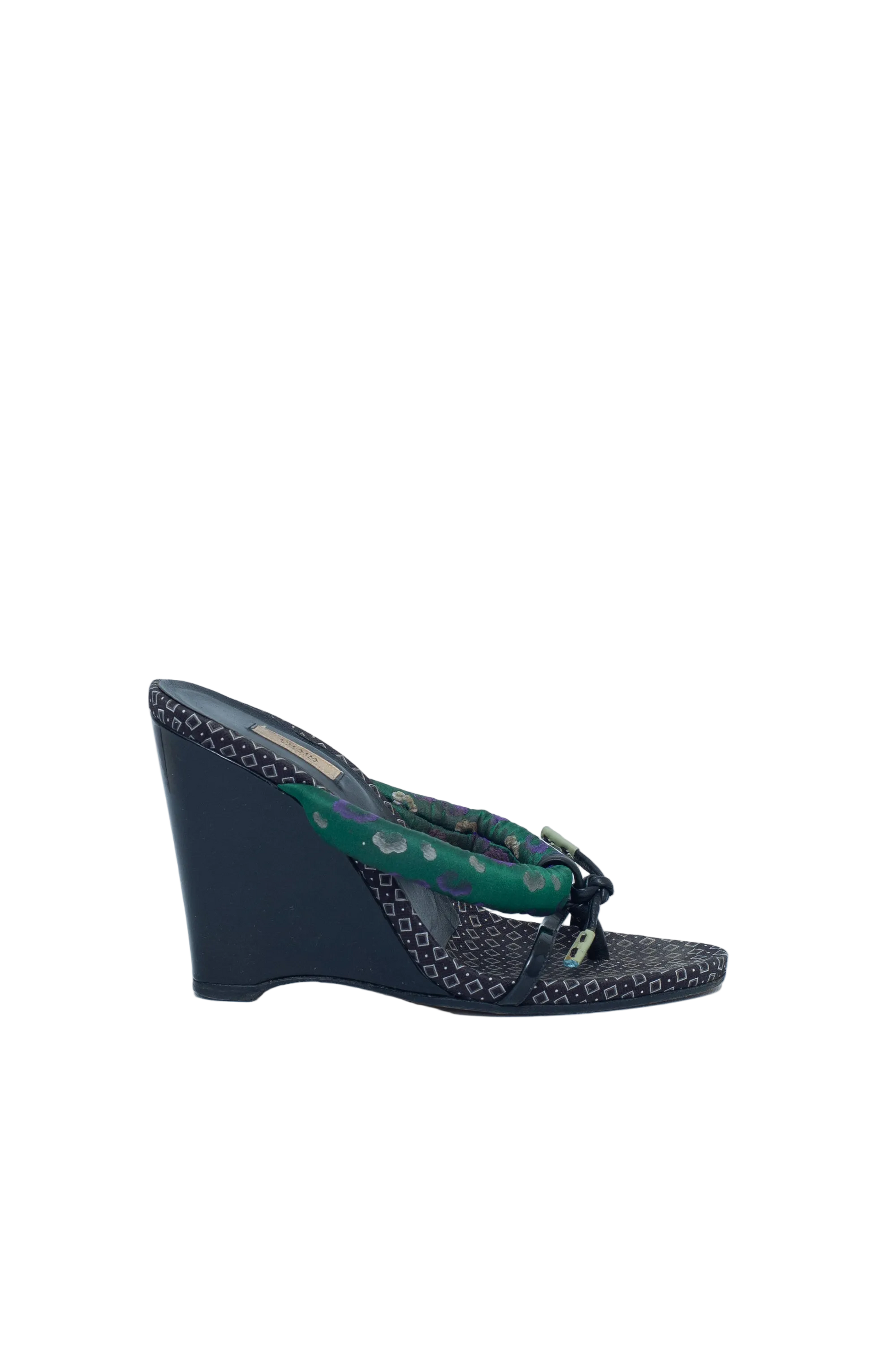 Black wedge sandal with green pattern on a white background