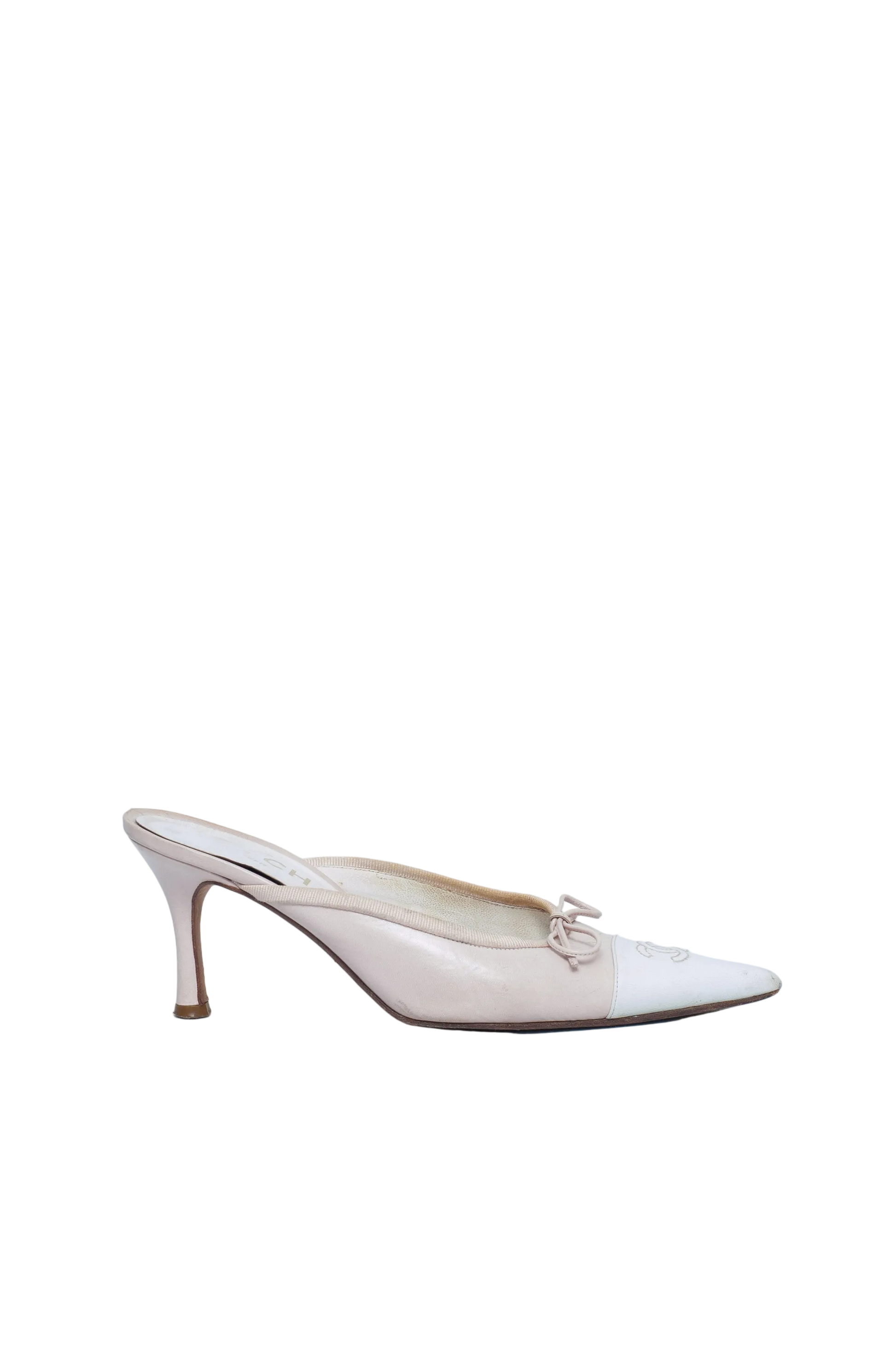 White high-heeled shoe on a light blue background