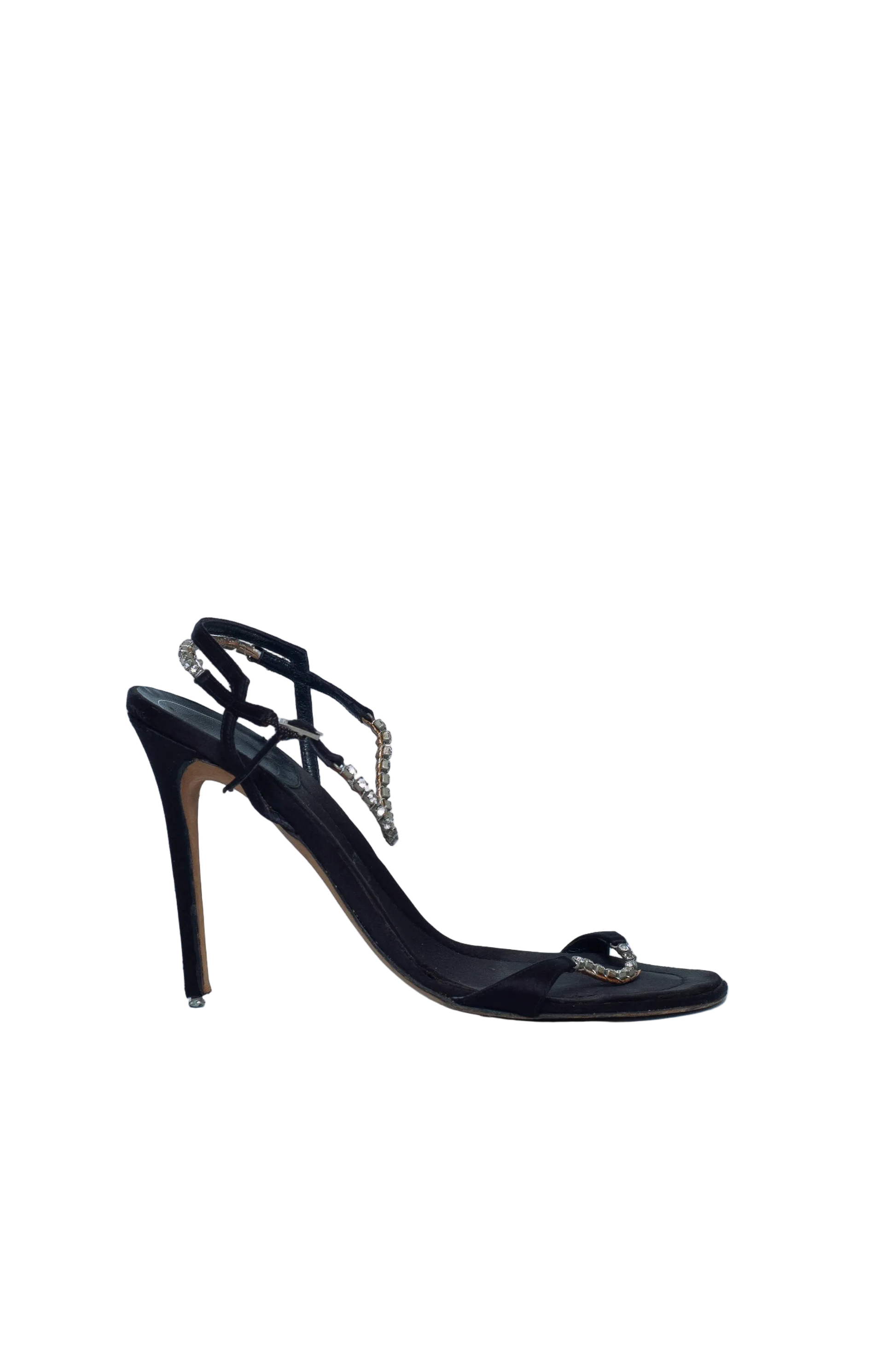 Black high-heeled shoe with decorative elements on a light gray background