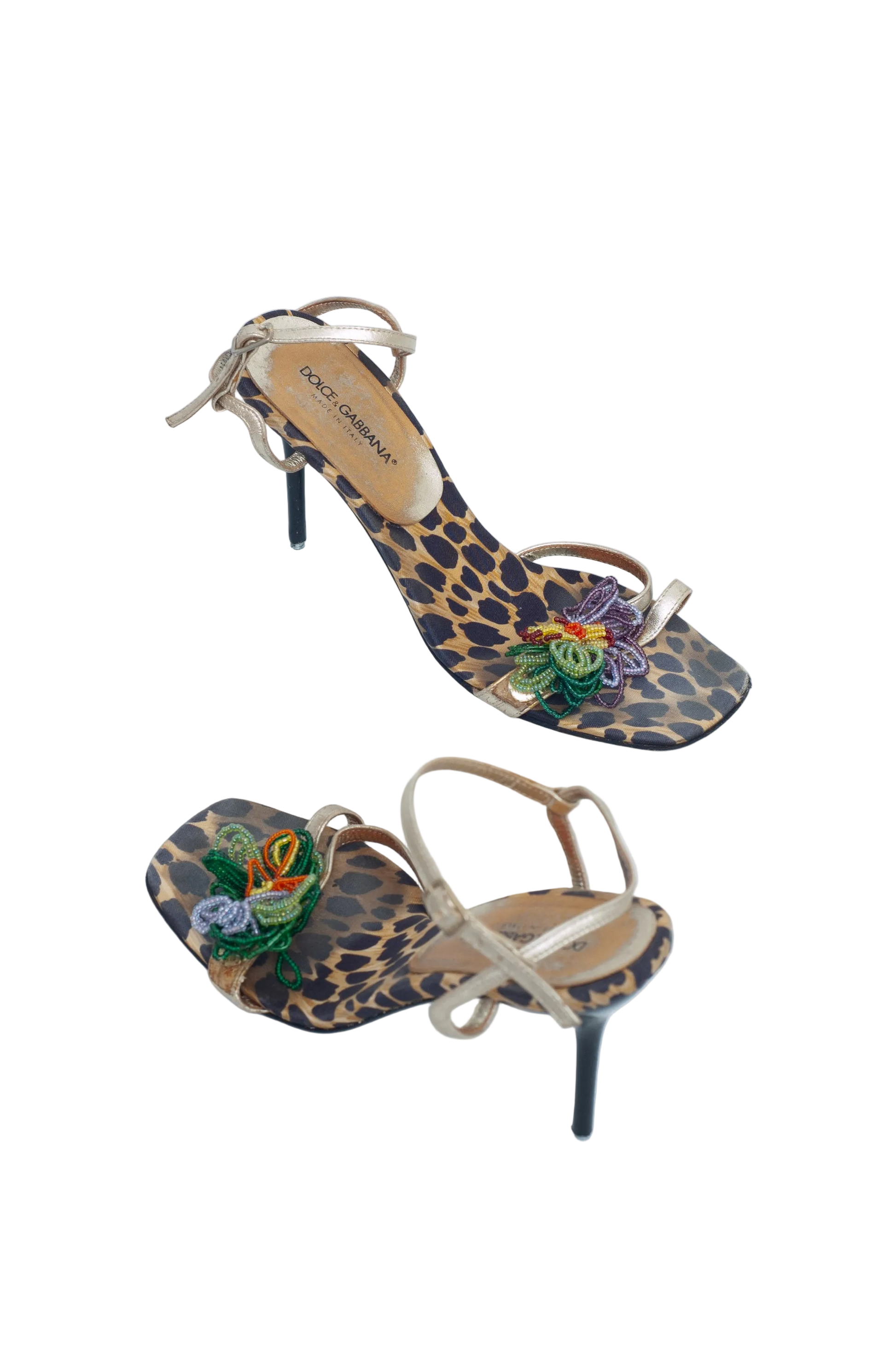 Pair of high-heeled shoes with leopard print and floral design on a white background