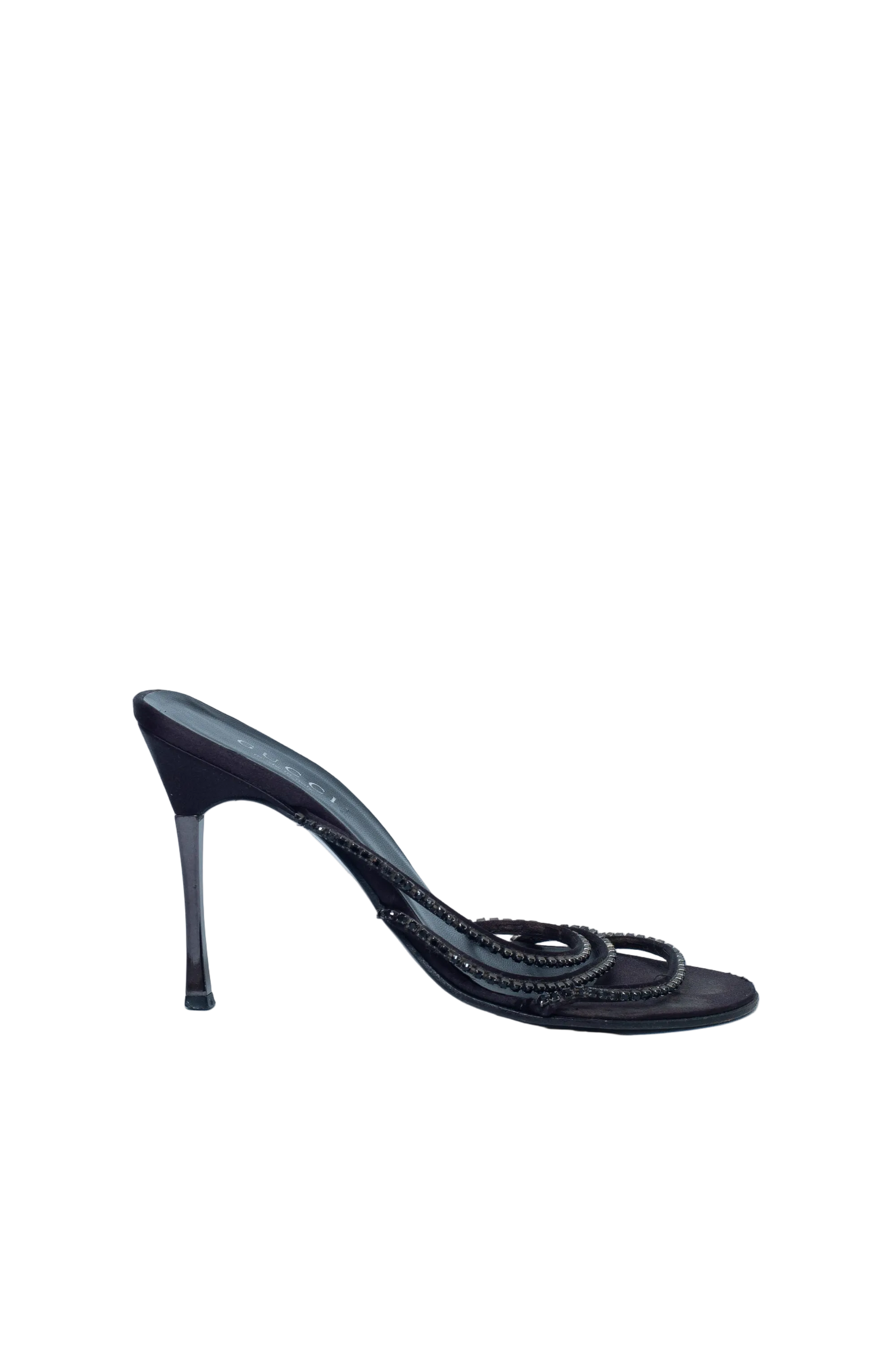 Black high-heeled shoe with braided design on a light blue background