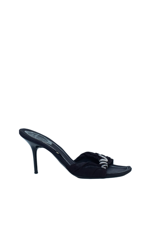 Black high-heeled sandal on a light gray background